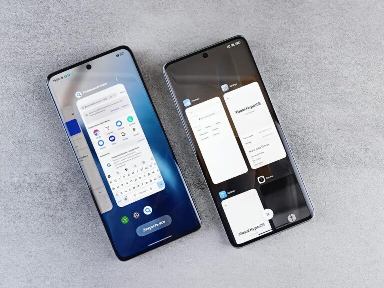 Two smartphones lying side by side on a grey surface, each showing a different app screen