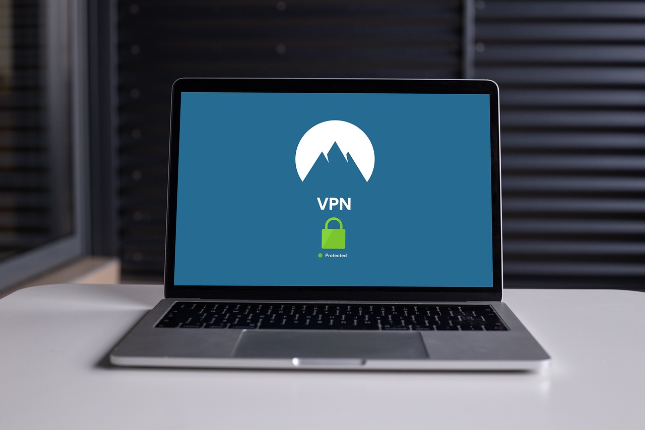 A laptop on a desk showing a VPN application connected, with a padlock icon on the screen