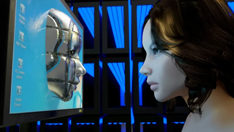 A polished metallic humanoid face on a blue screen, facing the profile of a woman looking at it