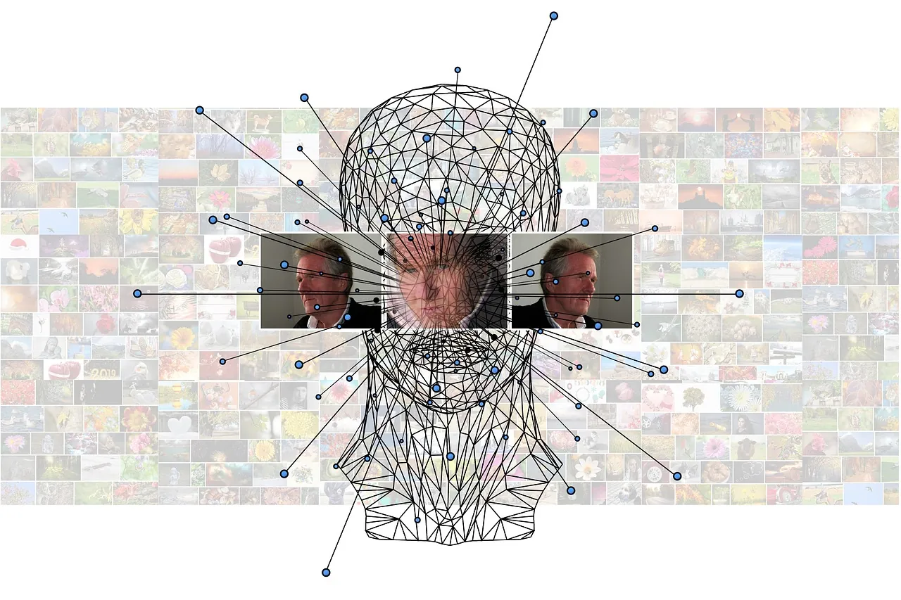 A wireframe model of a human head overlaid with facial recognition lines in front of a wall of small photographs