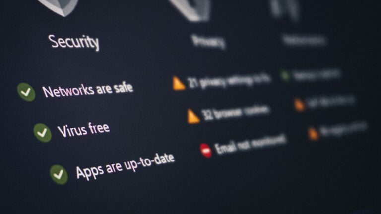 A security dashboard listing checks such as networks are safe, virus free and apps up to date, with green ticks and amber warnings